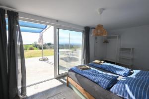 a bedroom with a bed and a sliding glass door at Summer house Spiti Pirgos in Epanomi