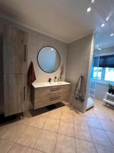 a bathroom with a sink and a mirror at Big villa with outbuilding in Sarpsborg +21 photos