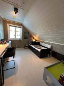 a room with a bed and a table in it at Big villa with outbuilding in Sarpsborg