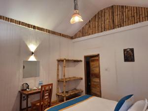 a bedroom with a bed and a table and a desk at AMBOKILI COTTAGES AMBOSELi in Nairobi