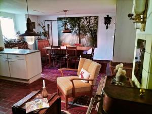 a living room with a kitchen and a table at B&B Herberg im Eichberg in Dettighofen