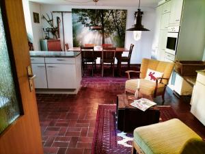 a living room with a kitchen and a dining room at B&B Herberg im Eichberg in Dettighofen +29 photos