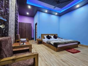 a bedroom with a bed and a blue light at Sangti River Front Homestay in Dirang Dzong