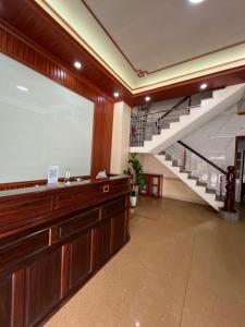 a lobby with a large window and a staircase at An Phú Stay & Coffee in Cửa Lô