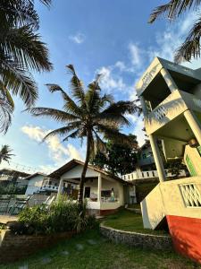 a palm tree in front of a building at Rella Dream in Matara