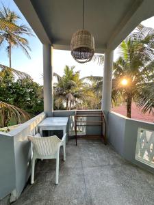 a porch with a table and chairs and palm trees at Rella Dream in Matara +45 photos