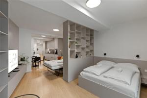a bedroom with a bed and a dining room at LAM Schon - AC in Bratislava