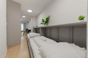 a row of beds in a room at LAM Schon - AC in Bratislava +4 photos