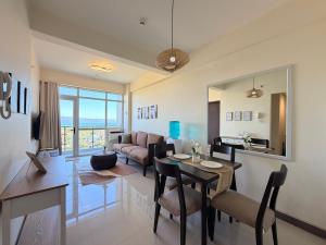a living room with a dining table and a living room at Serenity Ocean Garden Boracay in Boracay