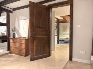 an open wooden door in a room with a dresser at Maison Alsacienne 4Ch & Suite Parentale sur la Route des Vins in Marlenheim