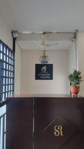 a counter with a sign on the wall in a room at Masterkey stay in Kakkanad