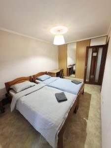 a bedroom with two beds and a mirror at 1 Double Budget Room Center Park in Chişinău +21 photos