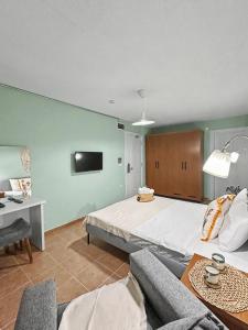 a large bedroom with a large bed and a couch at Hanole Macaron Guest House in Ayvalık