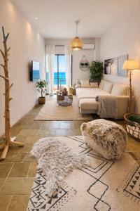 a living room with a couch and a table at SeaTerra Boutique suite in Kalamos