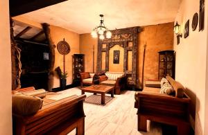 a large living room with couches and a table at Shvaas Boutique Villa in Dambawelagama