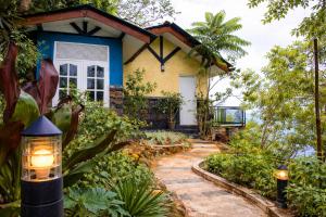 a house in the middle of a garden at Shvaas Boutique Villa in Dambawelagama