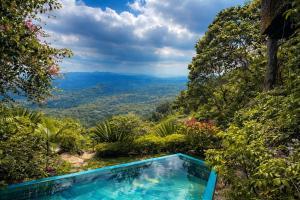 a swimming pool with a view of the mountains at Shvaas Boutique Villa in Dambawelagama