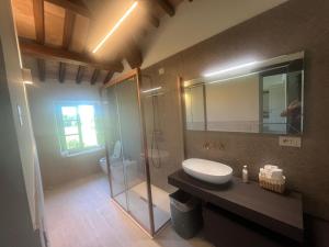 a bathroom with a shower and a sink and a toilet at Antico Casale Mevania in Bevagna +122 photos