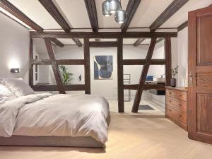 a bedroom with a bed and a dresser in a room at Maison Alsacienne 4Ch & Suite Parentale sur la Route des Vins in Marlenheim