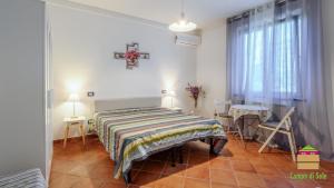 a bedroom with a bed with a cross on the wall at In Vino Veritas B&B in Arcola