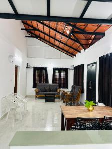 a living room with a couch and a table at Mausam Homestay in Sultan Bathery