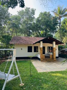 a small house with a porch at Mausam Homestay in Sultan Bathery +3 photos
