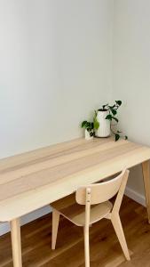 a wooden desk with two potted plants and a chair at La Porta Rosa in Bunbury +9 photos