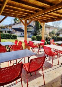a group of tables and chairs under a pavilion at Le Clos Nicolas in Eugénie-les-Bains