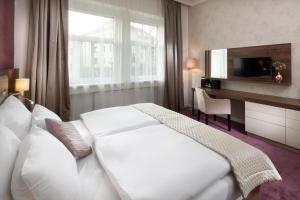 Postel nebo postele na pokoji v ubytování Mamaison Residence Sulekova Bratislava