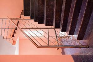 a metal staircase with a glass rail at M Balaji inn in Vellore