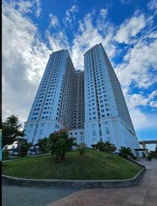 a large white building with two tall buildings at Luxury Studio Infinity Pool Golden Bay in Danang