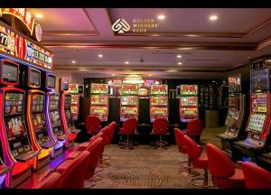 a casino with many slot machines and red chairs at Luxury Studio Infinity Pool Golden Bay in Danang