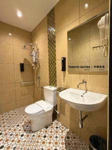a bathroom with a toilet and a sink at Tokiyo Suites Hotel Kinta River Ipoh Town in Ipoh +26 photos