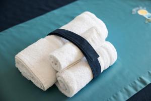 a stack of white towels sitting on a table at Casa Celeste Sea View - Riviera Collection in Misano Adriatico
