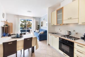 a kitchen and living room with a table and chairs at Casa Celeste Sea View - Riviera Collection in Misano Adriatico