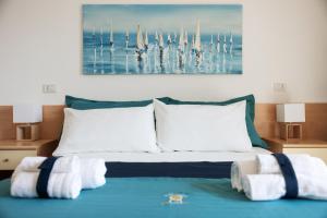 a bedroom with a large bed with two white pillows at Casa Celeste Sea View - Riviera Collection in Misano Adriatico