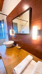 a bathroom with a sink and a mirror at Natural Elements by Levitate - Premium Two Room Chalet with Private Terrace Panoramic Forest View & Dedicated Kitchen in Rāmgarh