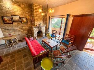 a living room with a fireplace and a table and chairs at Natural Elements by Levitate - Premium Two Room Chalet with Private Terrace Panoramic Forest View & Dedicated Kitchen in Rāmgarh