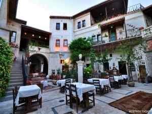a courtyard with tables and chairs in a building at Sofa Hotel in Avanos