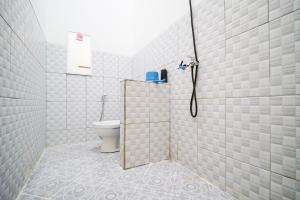 a bathroom with a shower with a toilet in it at Rayyan Homestay Jogja in Timuran +37 photos