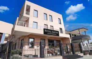 a building with a sign that reads royal suites at GREAT ROYAL eMPIRE in Tājganj