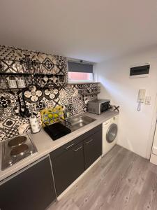 a small kitchen with a sink and a stove at ZK Zimmer in Stuttgart