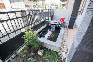 an overhead view of a koi pond on a balcony at Rayyan Homestay Jogja in Timuran