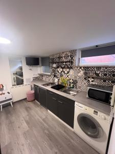 a kitchen with a sink and a washing machine at ZK Zimmer in Stuttgart