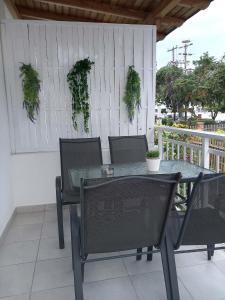 a glass table and chairs on a patio at Melirito in Olympiada +2 photos