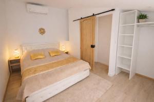 a bedroom with a bed with two yellow pillows on it at Maison cosy proche plage in Elne