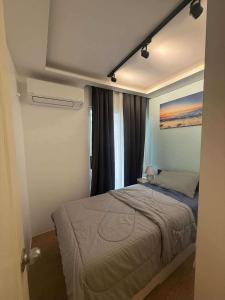 a bedroom with a bed and a painting on the wall at Sanremo Oasis Condo in Cebu City
