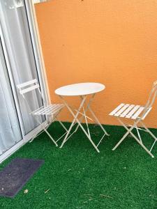 a table and two chairs sitting next to a window at Sanremo Oasis Condo in Cebu City