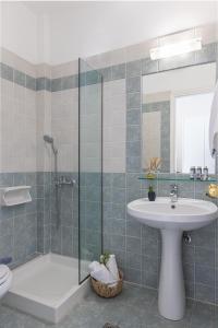 a bathroom with a shower and a sink and a toilet at Villa Anthemoessa - Endless Seaview in Pythagoreio +19 photos