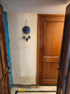 a hallway with a door and a lamp next to it at Uma's Homestay in Gwalior